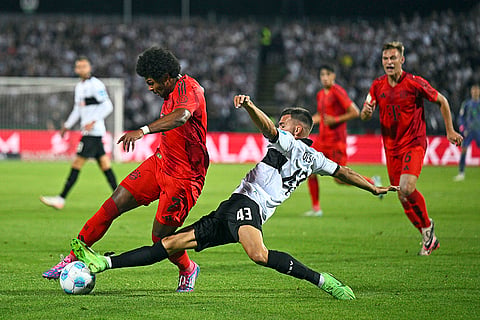 DFB-Pokal Ulm vs Bayern Munich: Serge Gnabry, left, and Ulm's Romario Rösch battle for the ball 